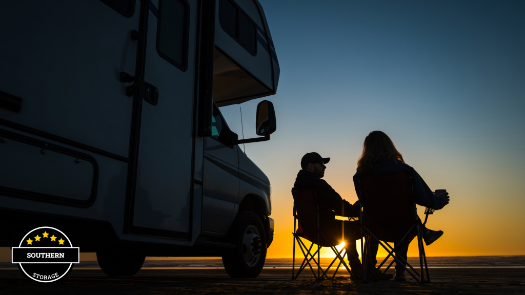 Two people relaxing in front of a camper at sunset in Fairhope, AL